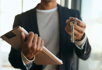 close-up-of-black-real-estate-agent-holding-key