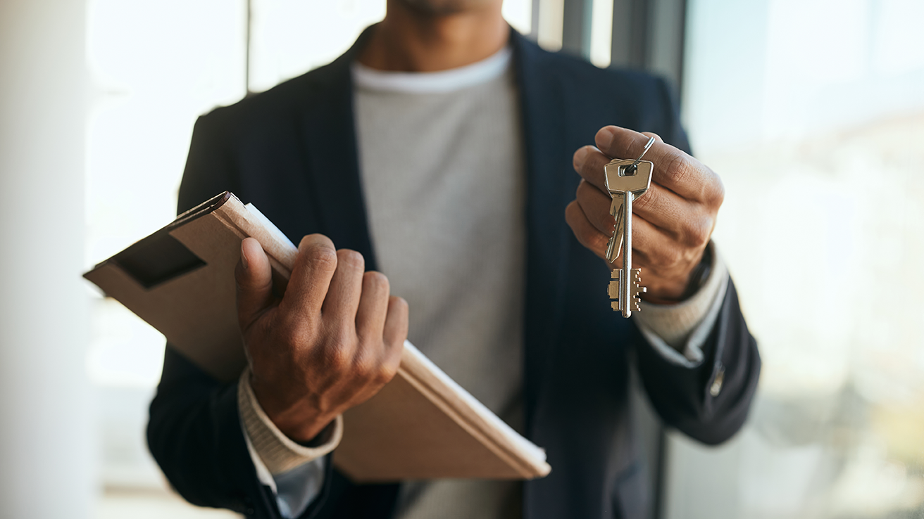 close-up-of-black-real-estate-agent-holding-key