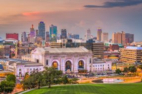 Kansas City, Missouri, USA downtown skyline with Union Station at dusk.